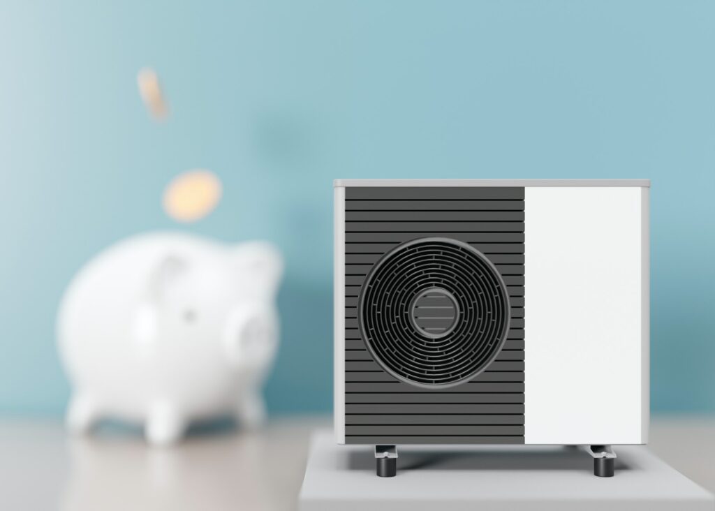 Air heat pump and piggy bank on blue background. Modern, environmentally friendly heating.