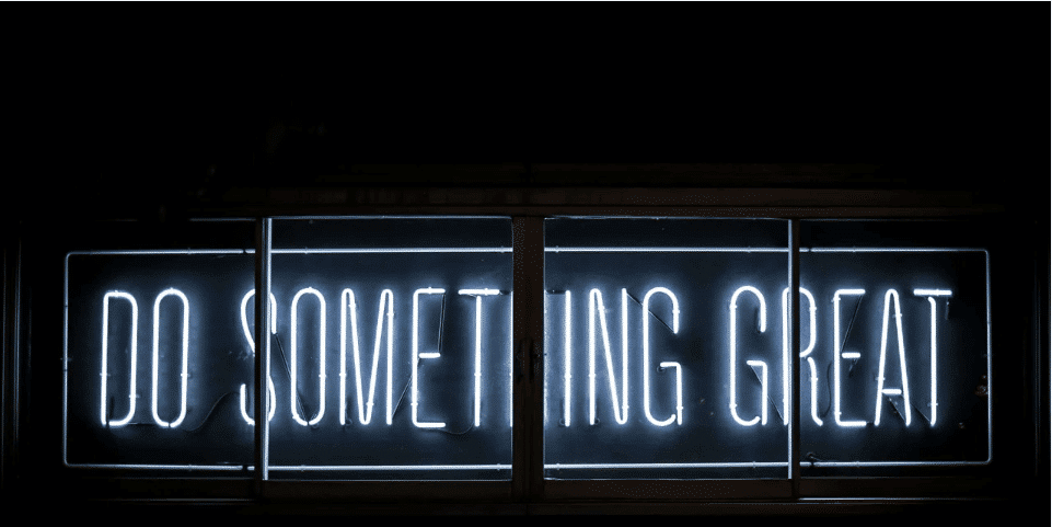 Neon sign saying "do something great"