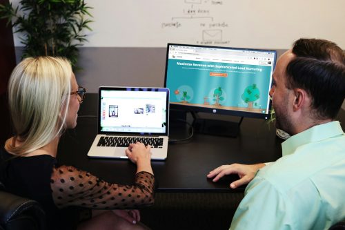 man and woman sitting down in front of table, Inbound Link Strategies