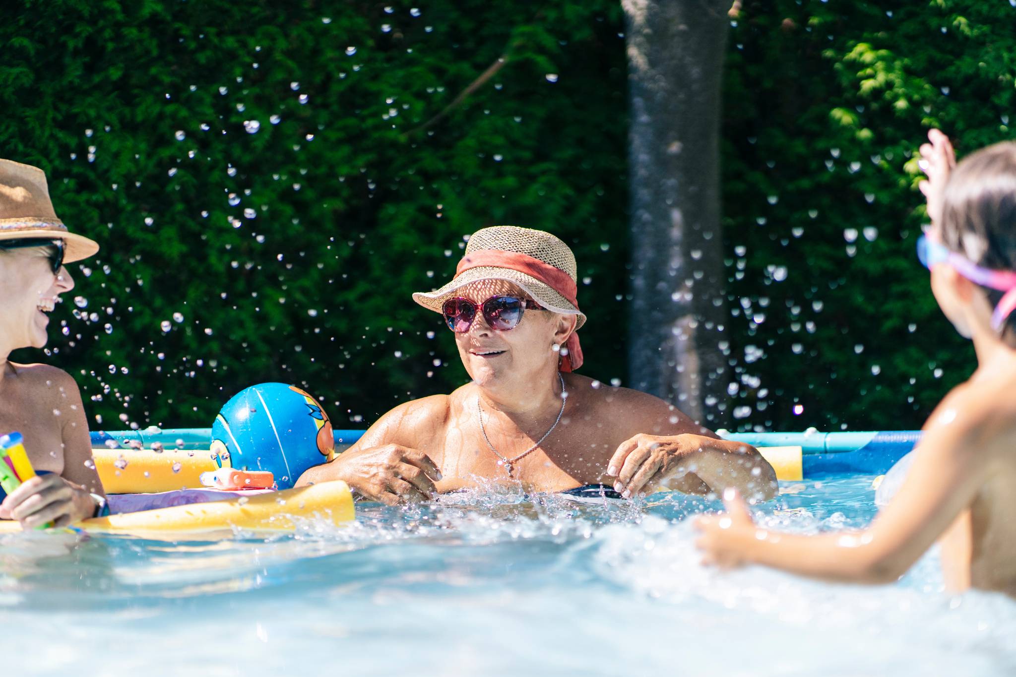 Släkt och familj som leker i pool i Karlstad