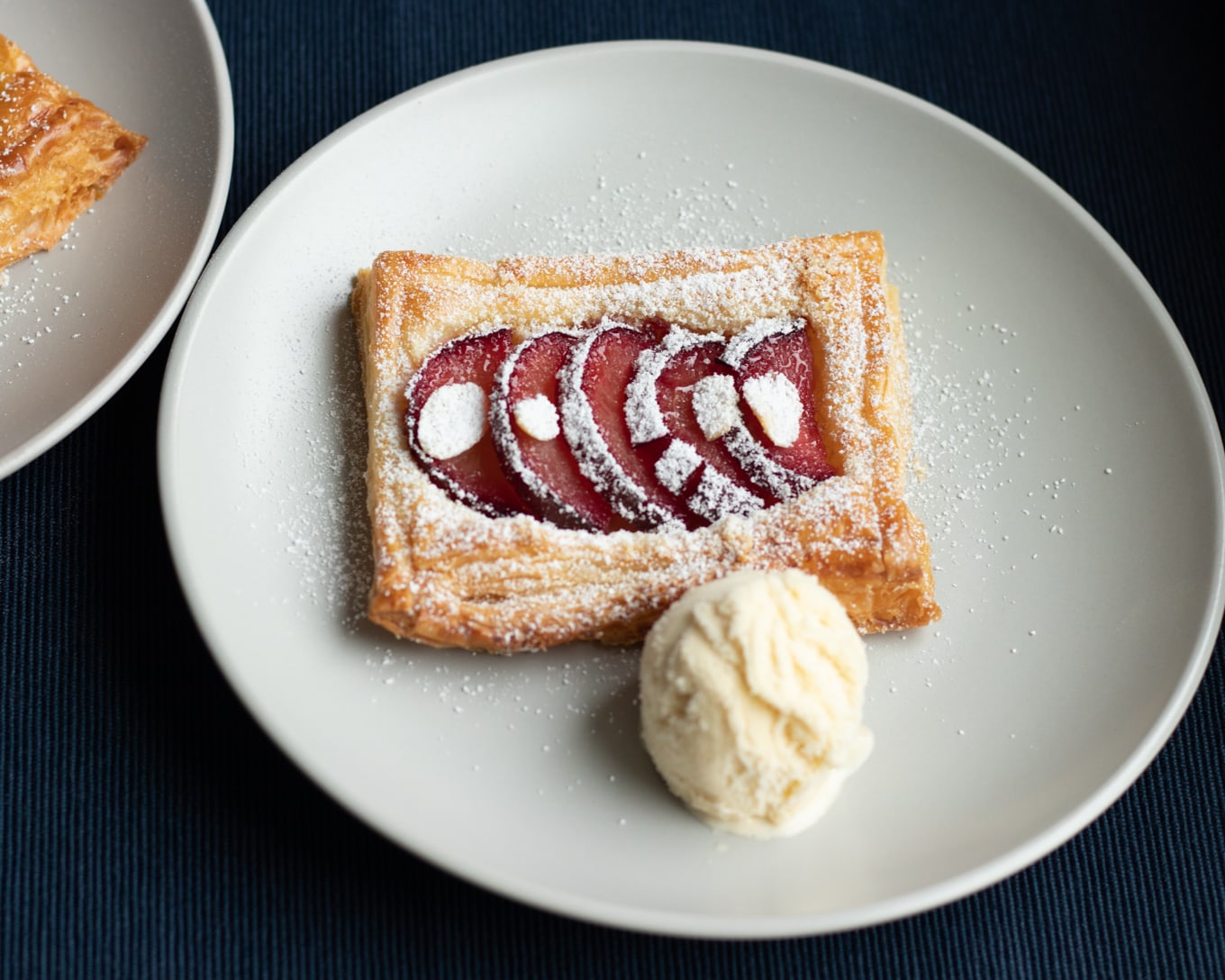 Plum tarts served with vanilla ice cream