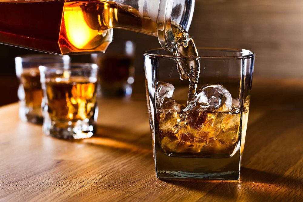 whiskey and natural ice on old wooden table
