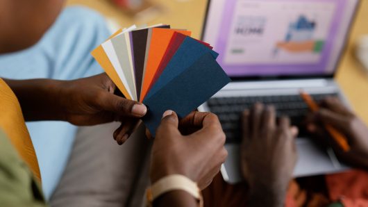 man-woman-making-plans-renovate-house-using-color-palette-laptop