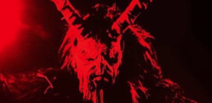 Black and red monochrome chest and up picture of a devil like man with horns