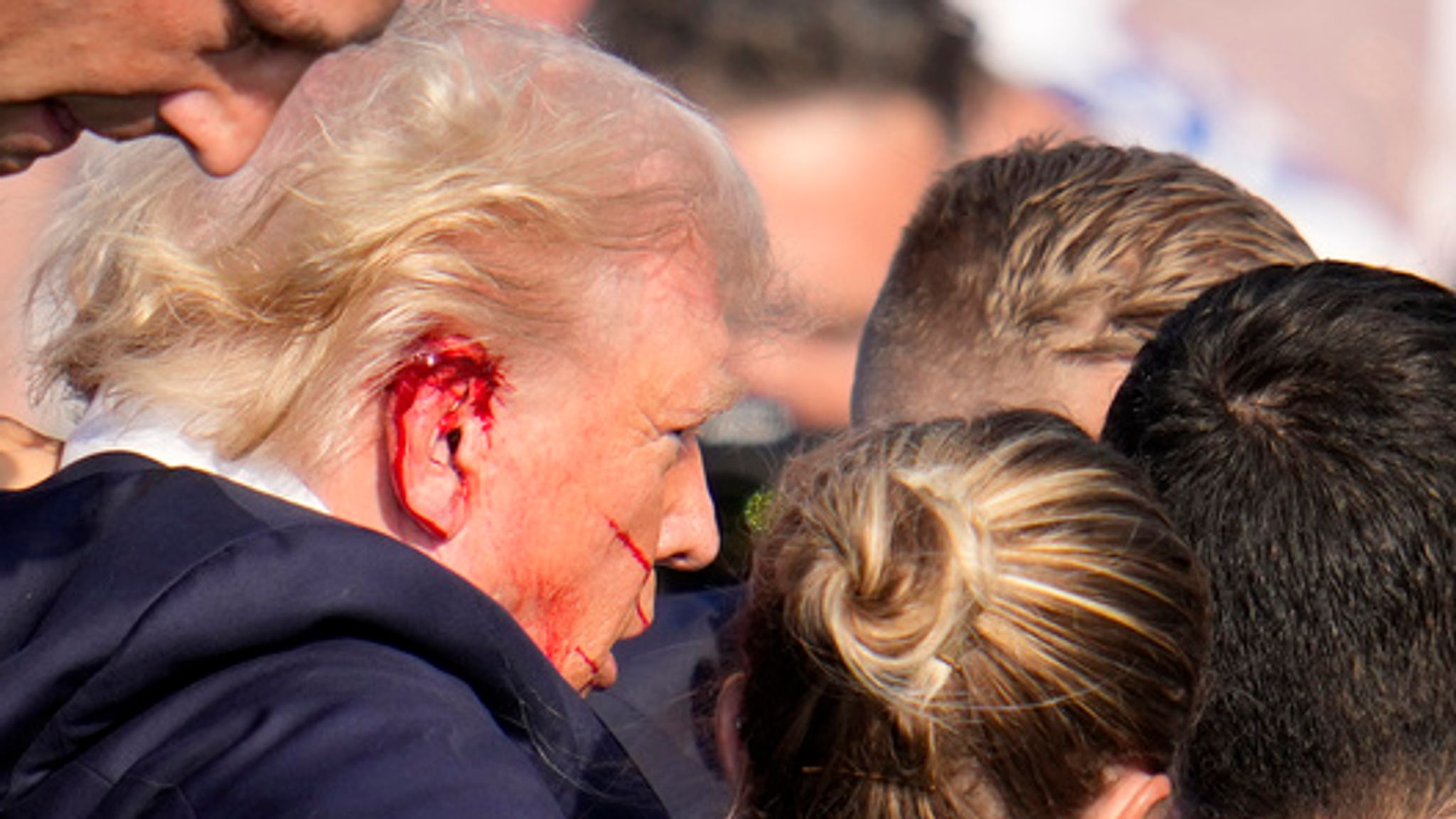 In Photos Trump whisked from stage at rally following apparent assassination attempt