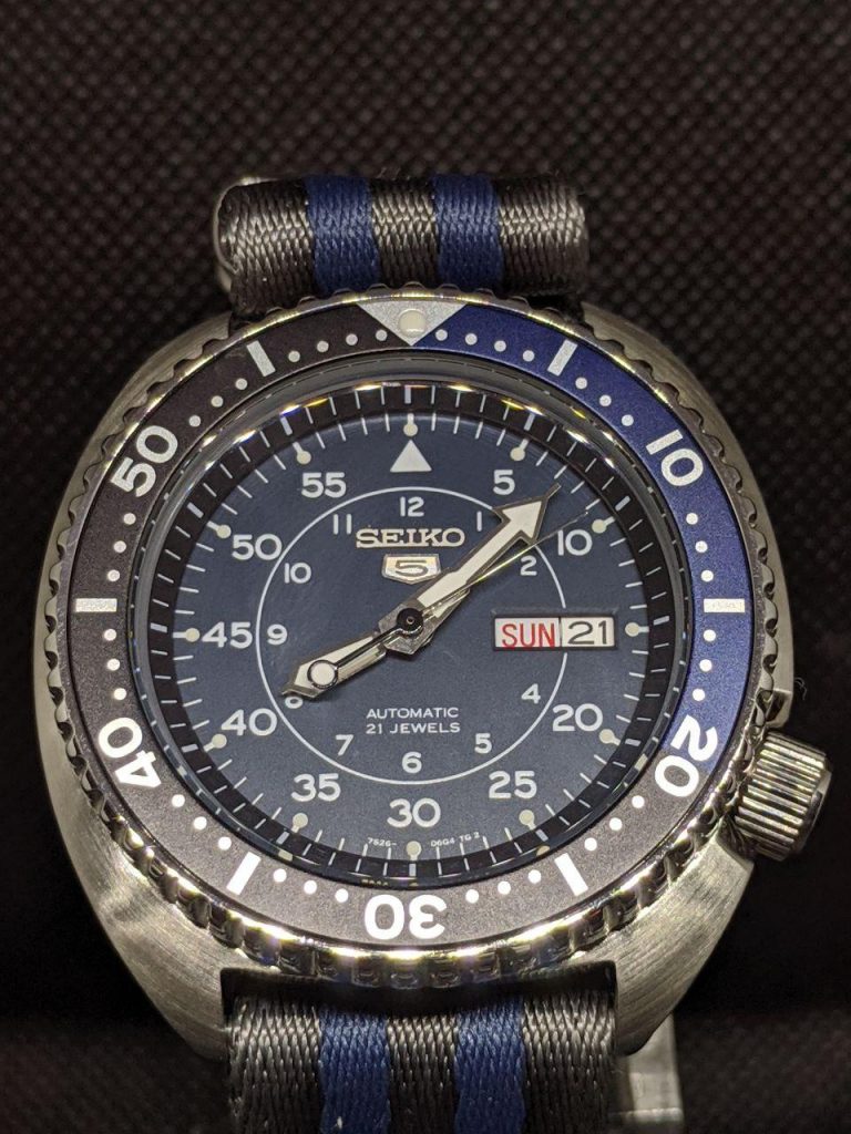 Seiko Mod by WellingTime UK. 
Seiko Turtle - SNK Military Mod: this mod includes SKX Hands, Blue Military Dial taken from a Seiko SNK, The bezel insertis in blue and dark grey matching the dial. Completed with a matching strap. This one is a beauty! 