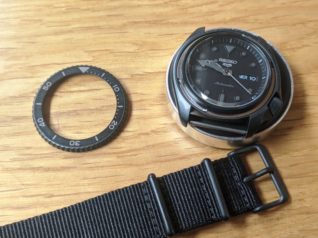 Seiko SRPD79 with Bezel removed (left), Displayed on a watchmakers cushion with the OEM NATO Strap, below. 