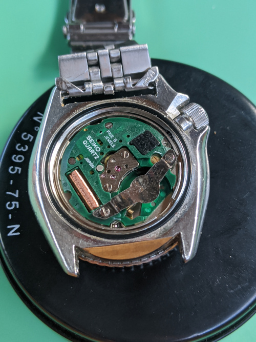 Seiko 7548 Service - Seiko 7548 700B Watch woth the caseback removed, displayed on a watchmakers cushion. WellingTime watch repair