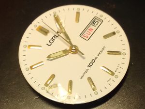 Watch Crystal Repair - Lorus Watch dial - with broken glass (watch crystal) sowing the potential damage that could be caused byt not addressing a broken or cracked watch crystal in good time