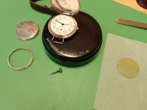 Watch Crystal Repair - Vintage trench watch crystal replacement displayed on a bergeon watchmakers cushion anti-static matt - Wellingtime watch crystal repairs 