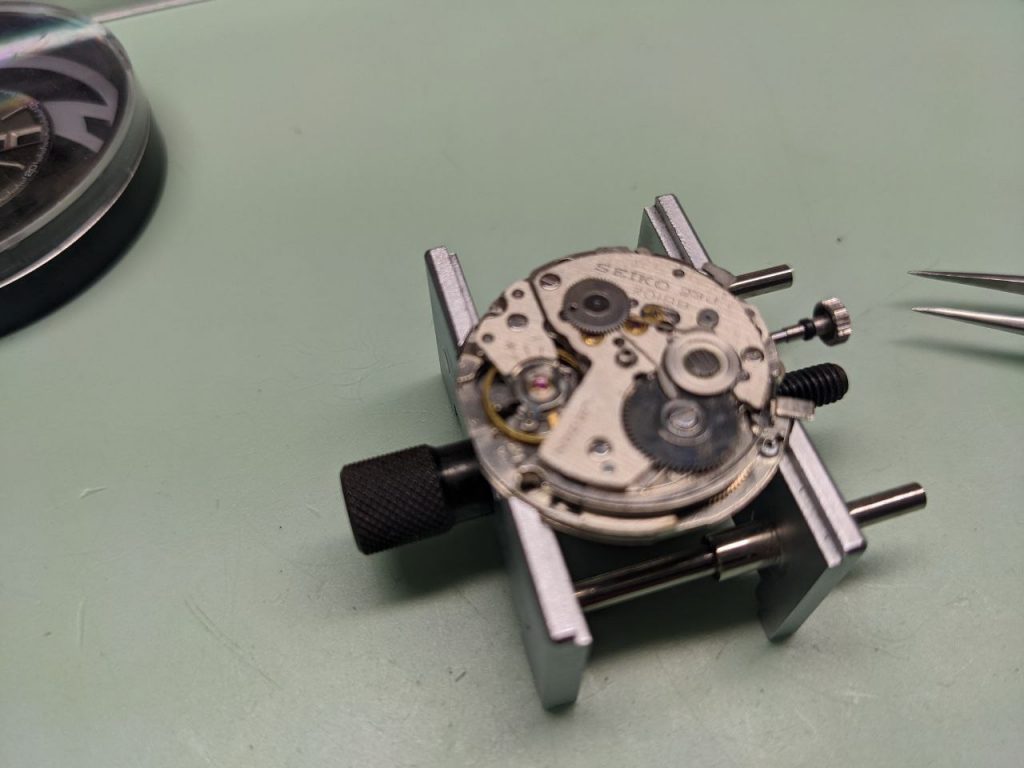 Seiko 7018 Repair Movement in movement holder ready for disasembly.