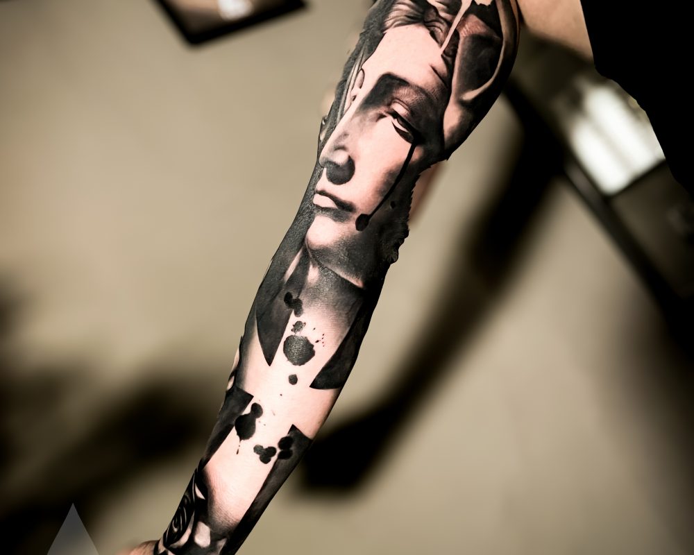 Virgin Mary cross graphical realism high contrast arm sleeve tattoo