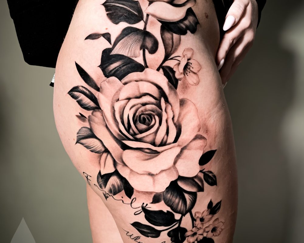 Realistic hip roses feminine tattoo design large-scale
