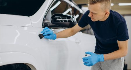 man-working-car-detailing-coating-car_1303-30594