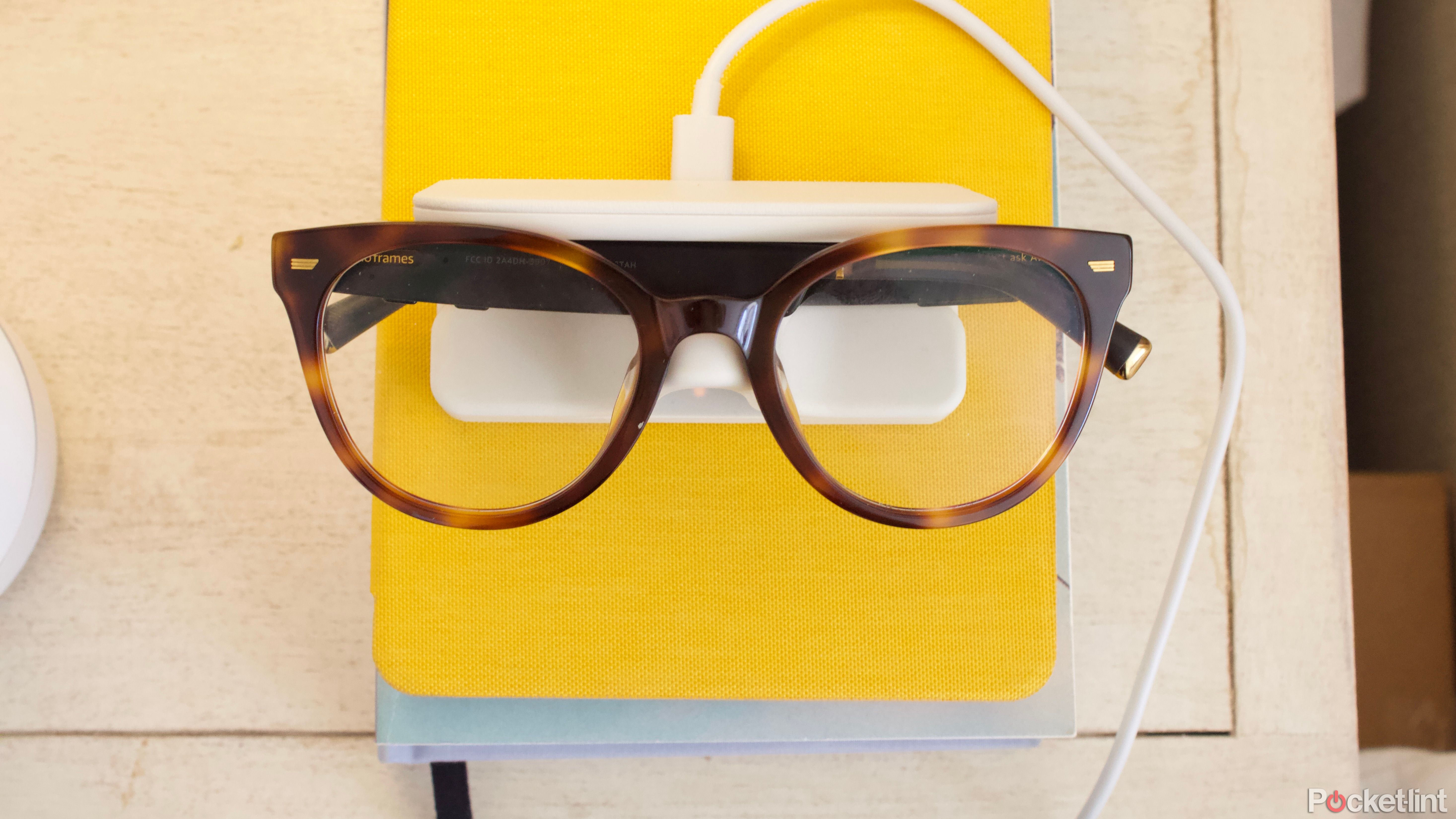 Amazon Echo Frames gen 3 on nightstand with yellow background