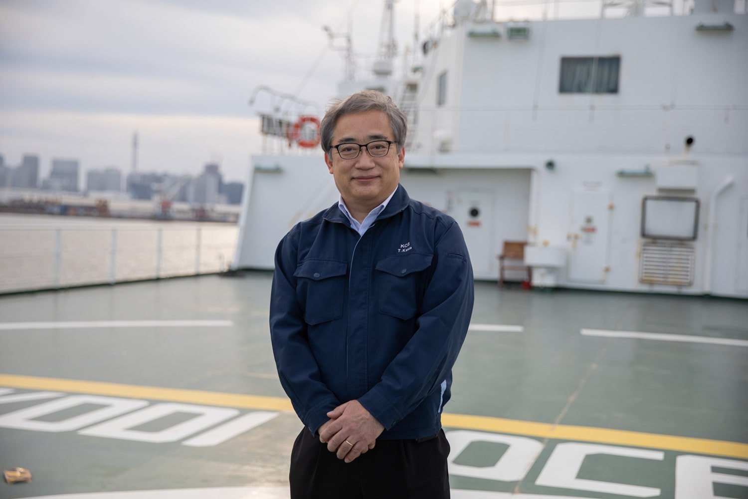 Kaida Takashi stands on the foredeck of the Ocean Link.