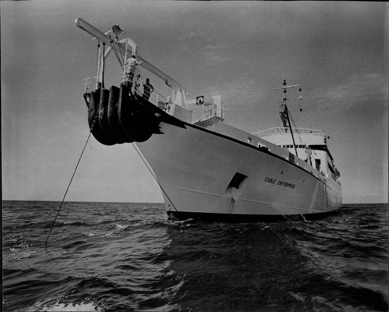 A black and white photograph of the bow of a cable ship.