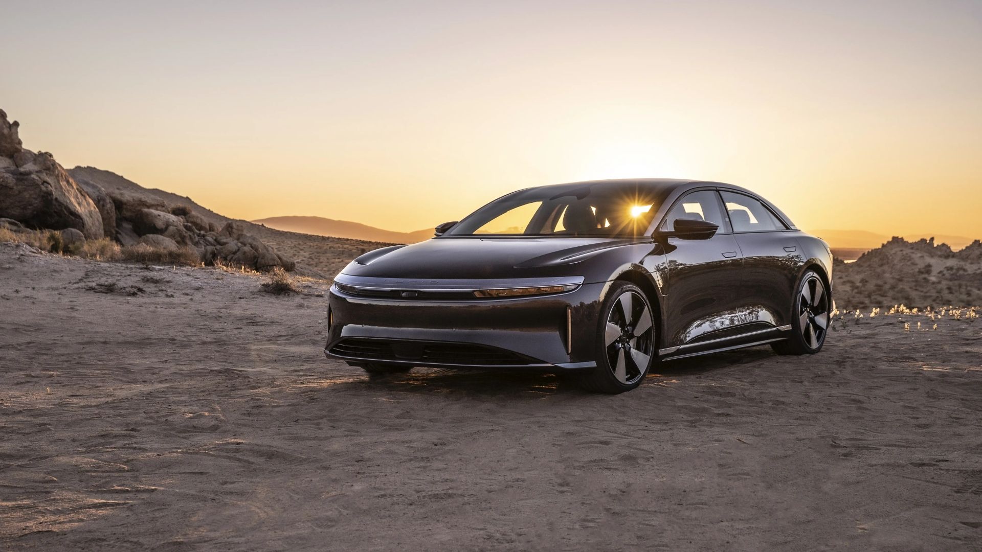 2024 Lucid Air Grand Touring front three-quarters view in a desert