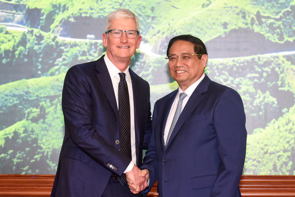 Vietnam's Prime Minister Pham Minh Chinh (R) shakes hands with Apple CEO Tim Cook (L) during a meeting at the Government Office in Hanoi on April 16, 2024. Tech giant Apple said it would increase spending on suppliers in Vietnam, a key production hub, as CEO Tim Cook arrived on April 15, 2024 in the country for a two-day visit. (Photo by Duc KHANH / AFP) (Photo by DUC KHANHDUC KHANH/AFP via Getty Images)