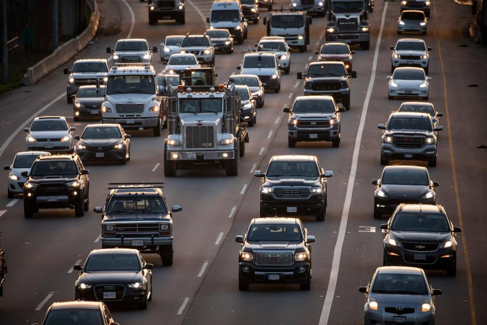 Vehicles are pictured driving in traffic along highway 1 in Burnaby, British Columbia on Wednesday, December 8, 2021. 