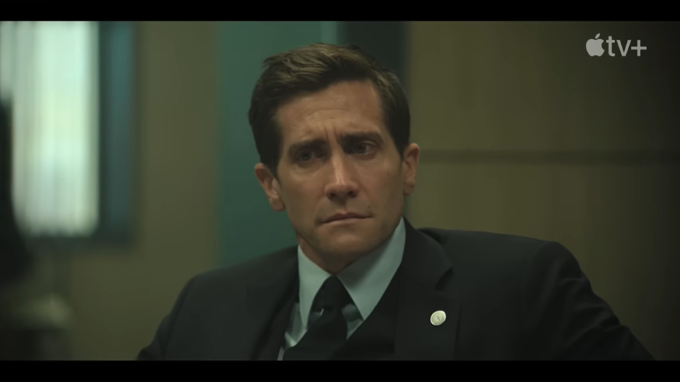 presumed innocent trailer, jake gyllenhaal looks worried while wearing a suit