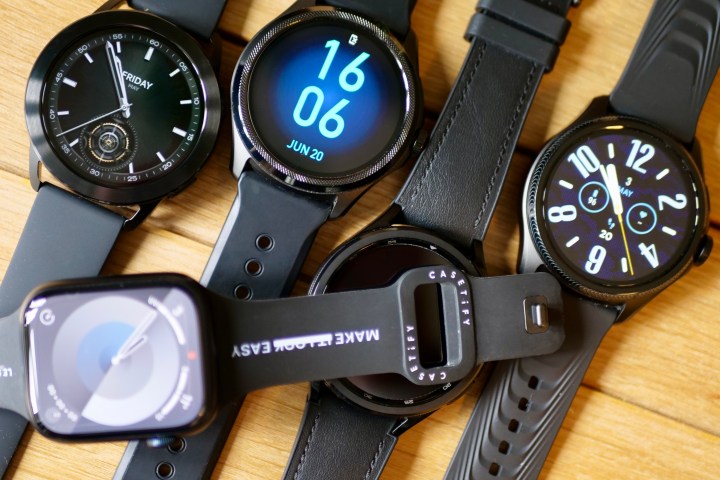 Different smartwatch models with displays illuminated.
