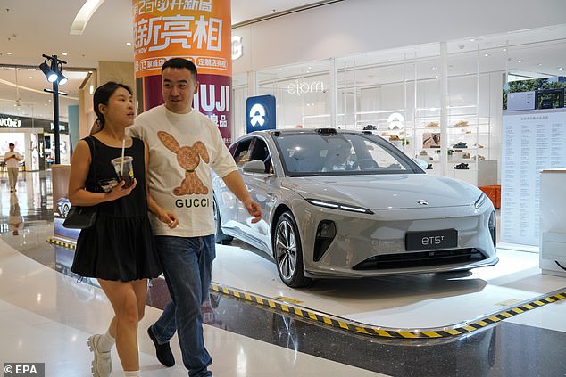 Chinese electric carmakers are tipped to flood Australia with cheap imports as the Americans and Europeans increase tariffs to protect their local vehicle manufacturers (pictured is a NIO ETS EV in Beijing)