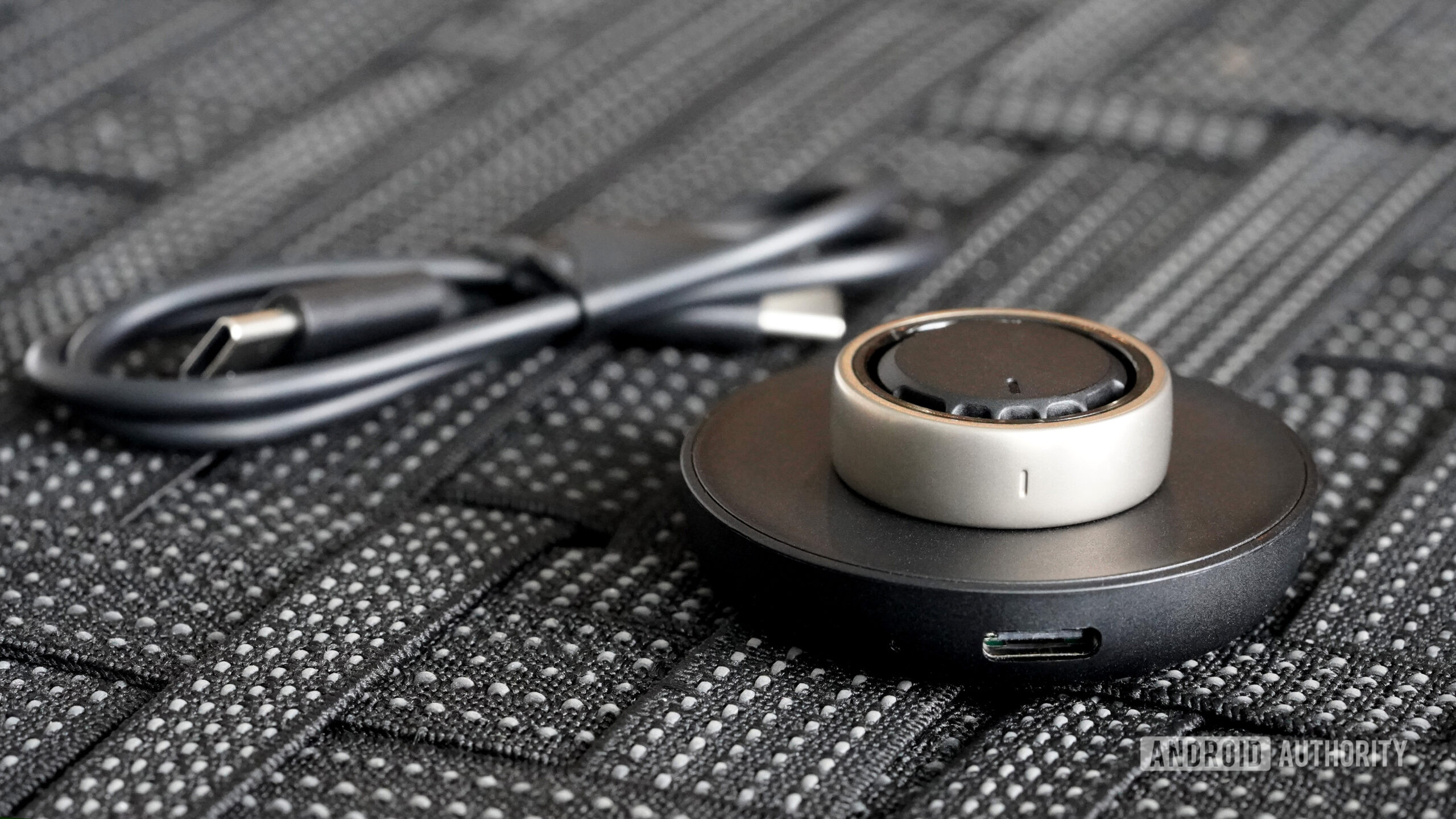 The Amazfit Helio Ring utilizes a cradle-style charger and USB-C cable.