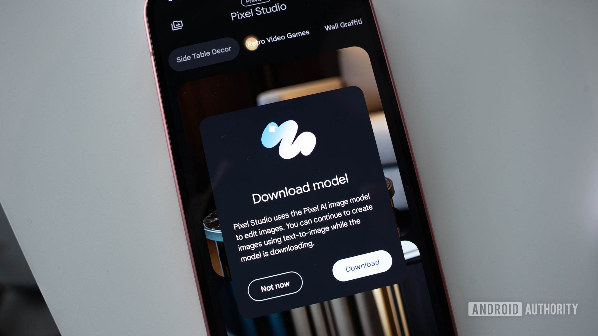 Google Pixel 9 with Pixel Studio app open showing a prompt to download a new AI image model