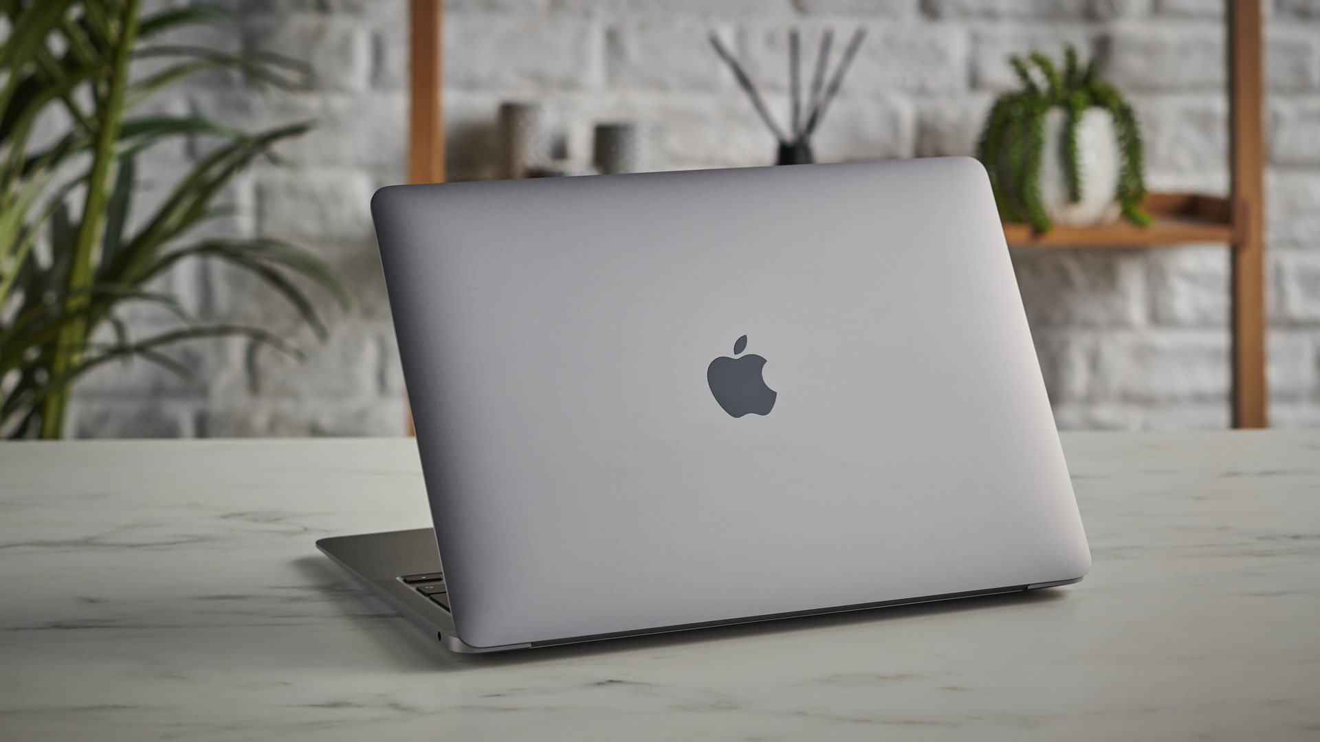 MacBook Air M1 on a table showing the lid and Apple logo