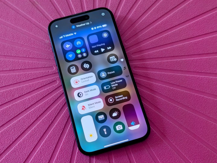 iPhone 15 Pro with iOS 18 Control Center.