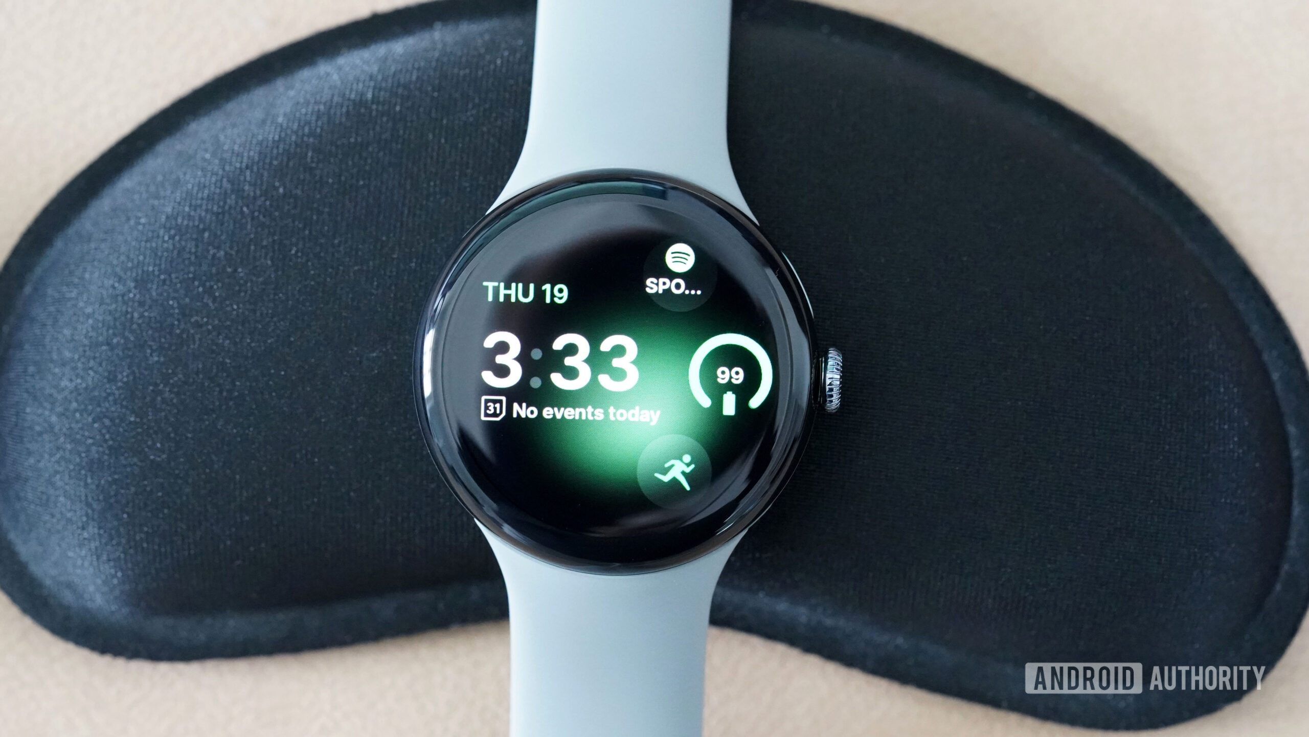 A Google Pixel Watch 3 displays the watch face Tidal Glow.