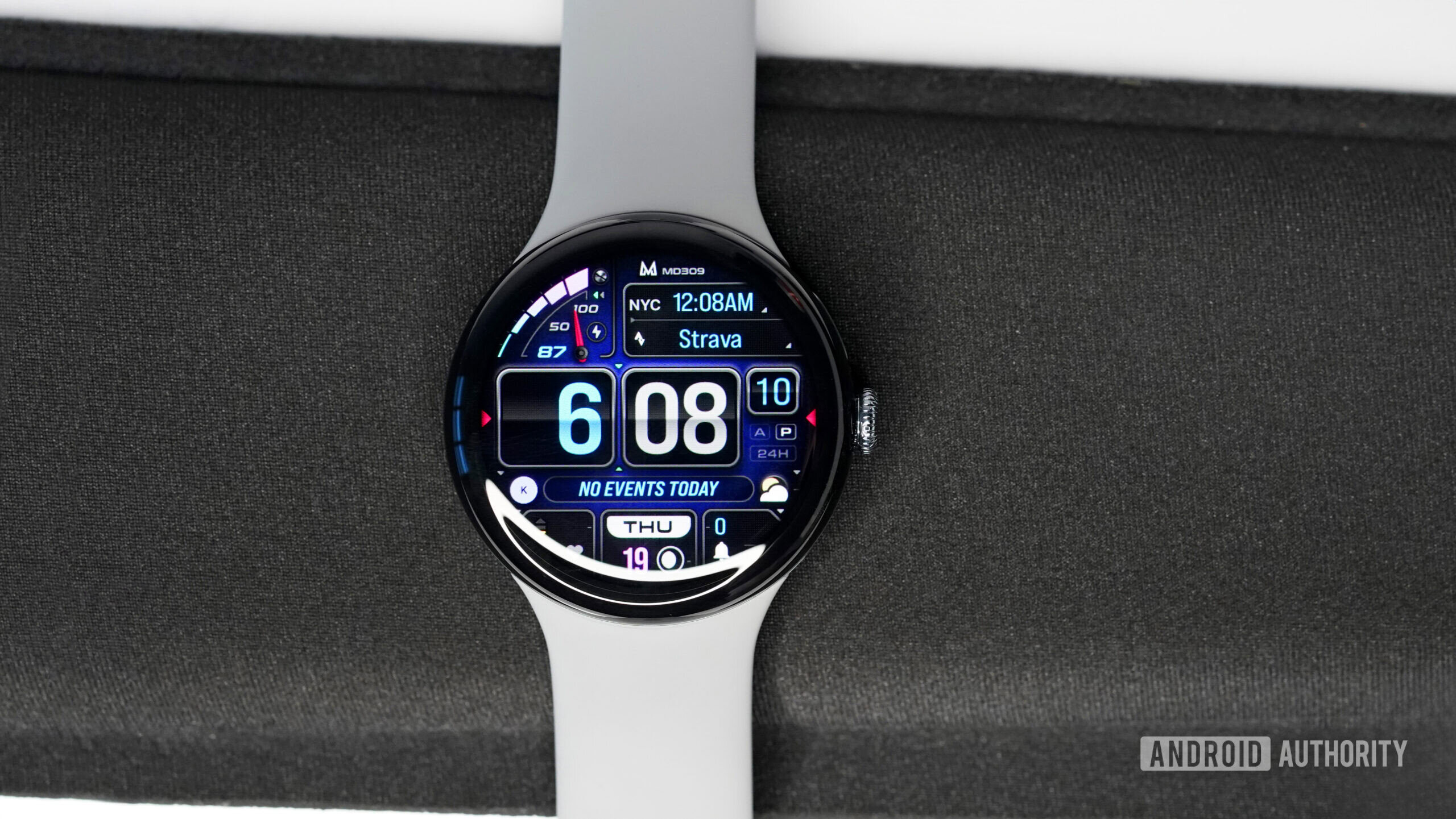 A Google Pixel Watch 3 displays the watch face MD309.