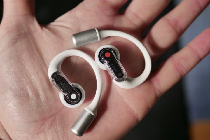 The Nothing Ear Open earbuds in a person's hand.