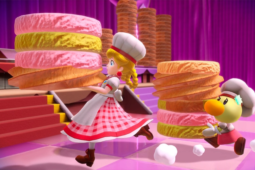 Princess Peach, dressed as a baker, runs as she carries a stack of huge cookies, with an apprentice in tow