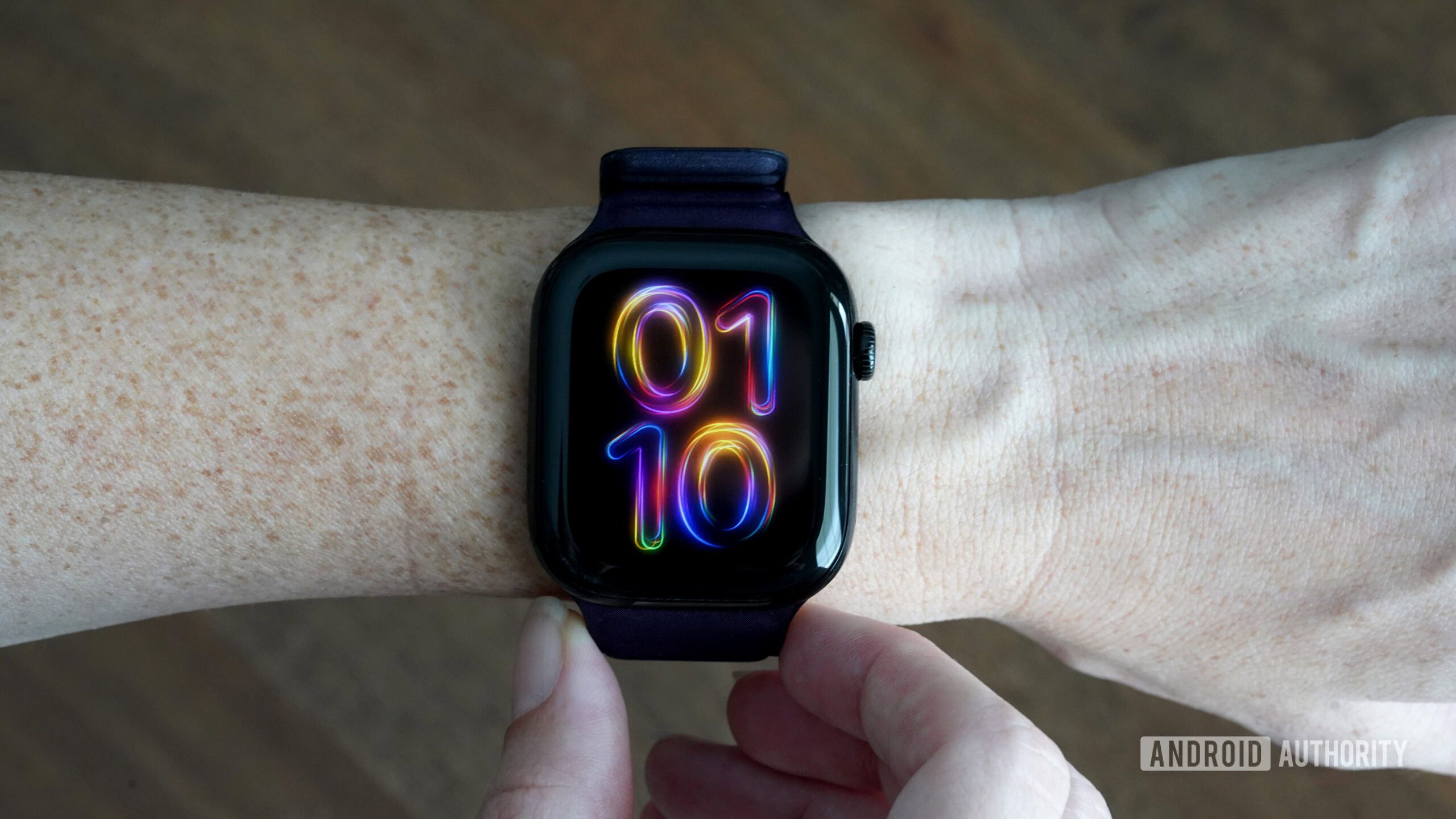 An Apple Watch Series 10 displays the watch face Pride Radiance.