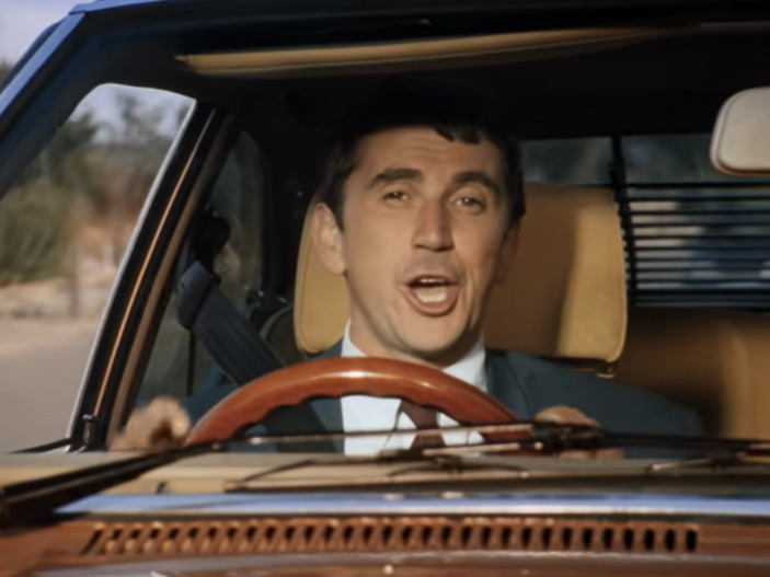 The iconic actor can be seen driving the old motor alongside Blur's lead singer Damon Albarn