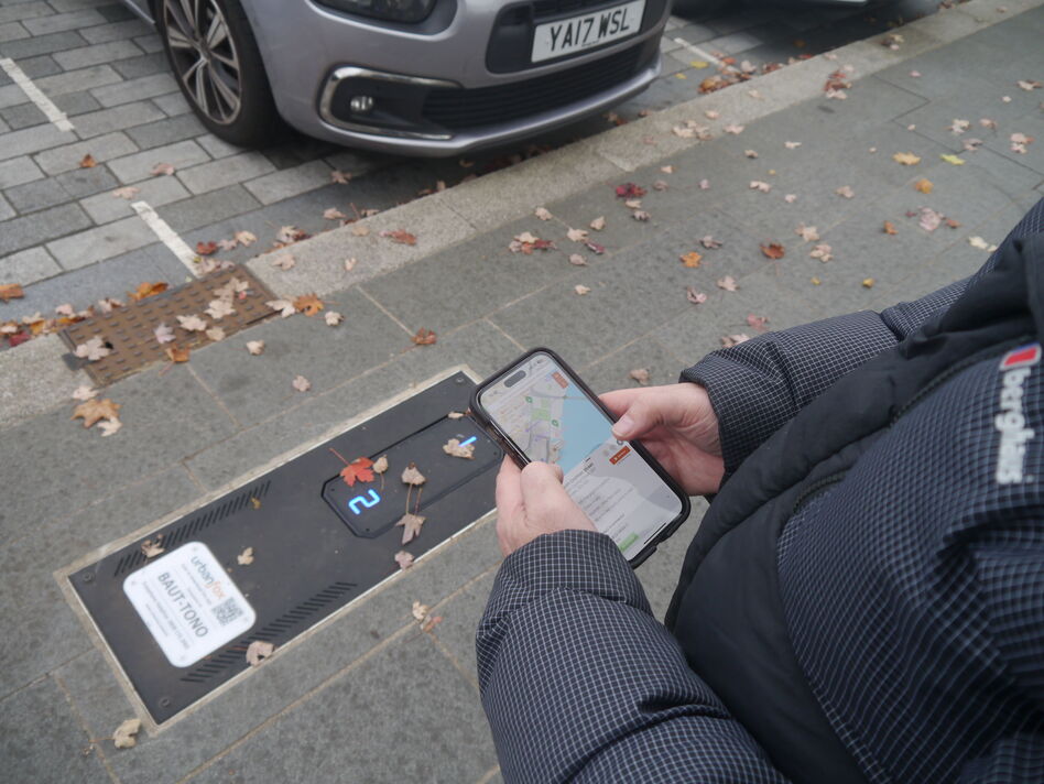 View of motorist unlocking a pop-up street charger