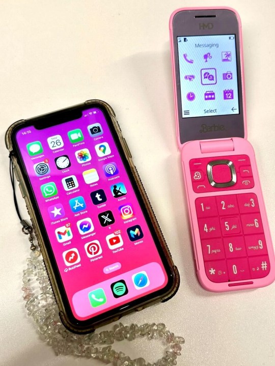 Courtney's iPhone 11 next to the Barbie flip phone