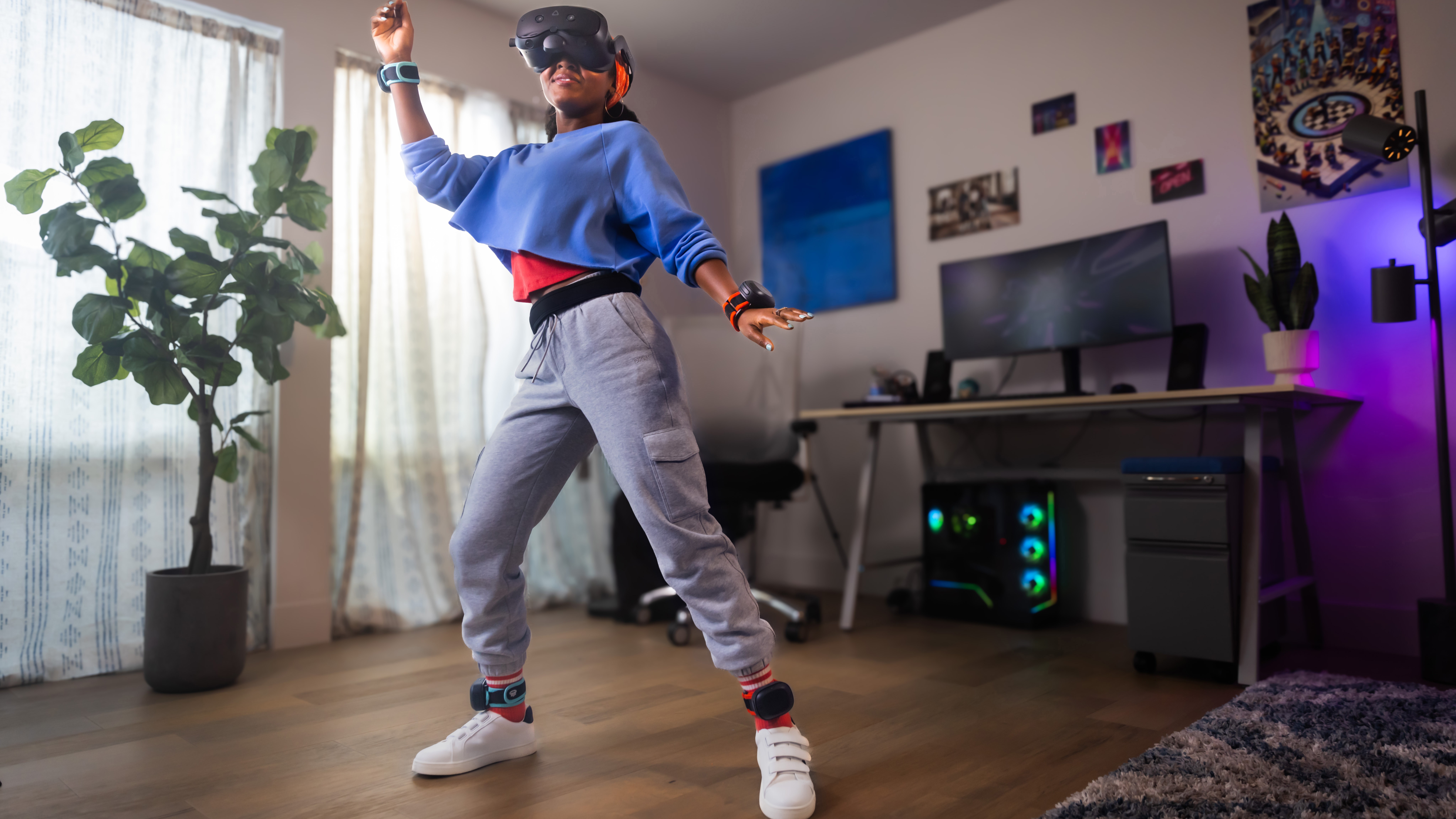 The HTC Vive Focus Vision being used by a dancer in their bedroom with a gaming PC behind them