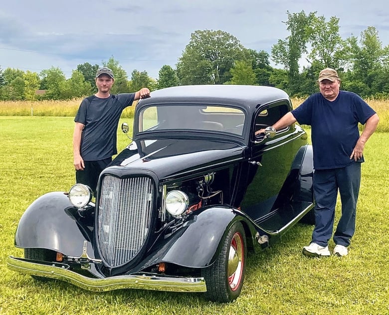 Wayne Evoy, and his son Christopher, pose next to the family's 1934 Ford Coupe. The Evoys purchased the car in June, 2021, and were the registered owners for three years before the vehicle was suddenly declared to have been stolen. 