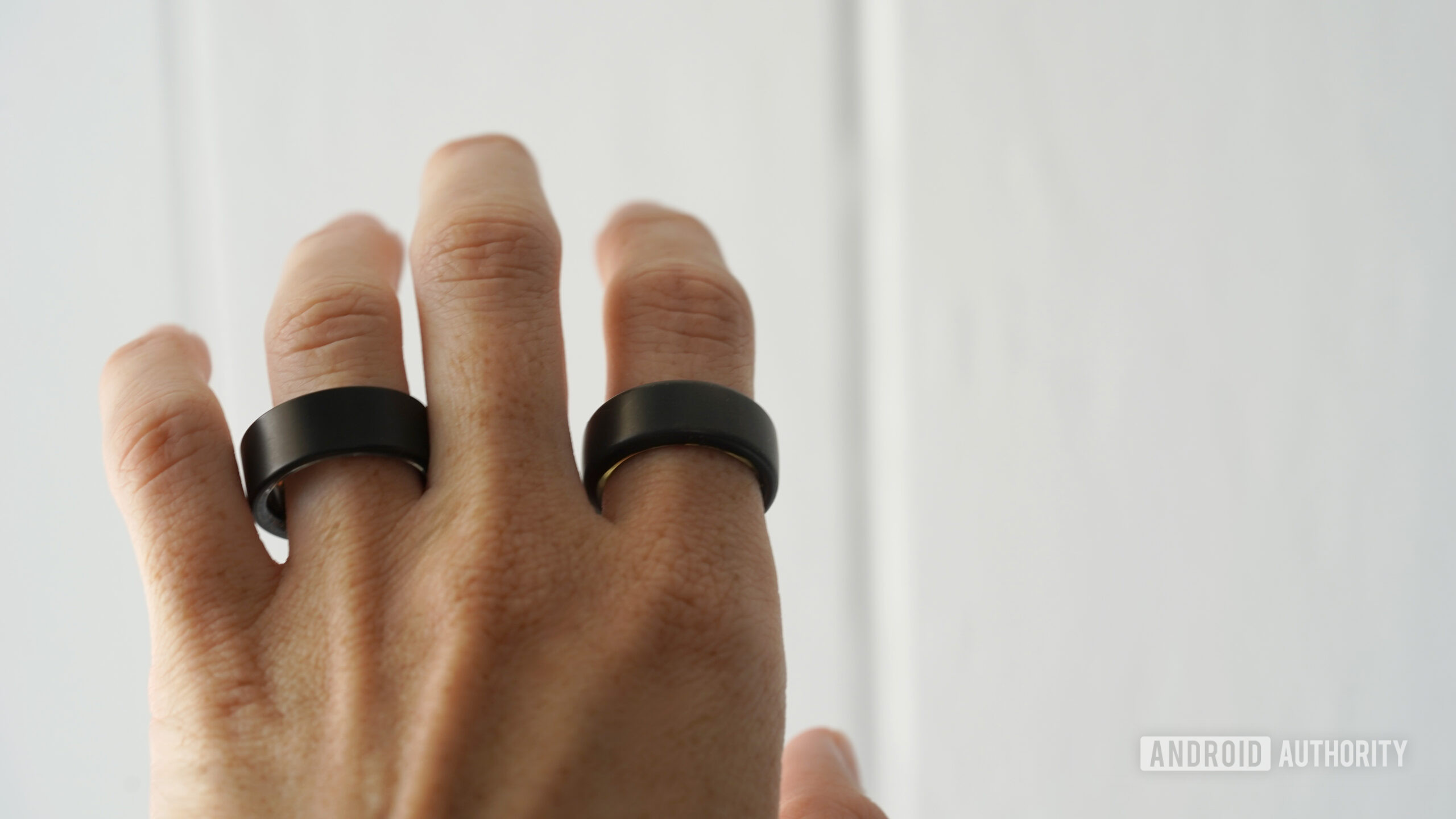 A smart ring user wears and Ultrahuman Ring Air and Oura Ring 3 at the same time.