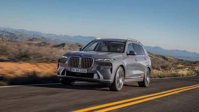 A gray BMW X7 driving in the desert