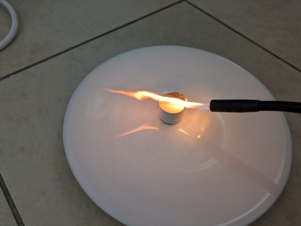 Lighting a smoke pellet prior to an air purifier test