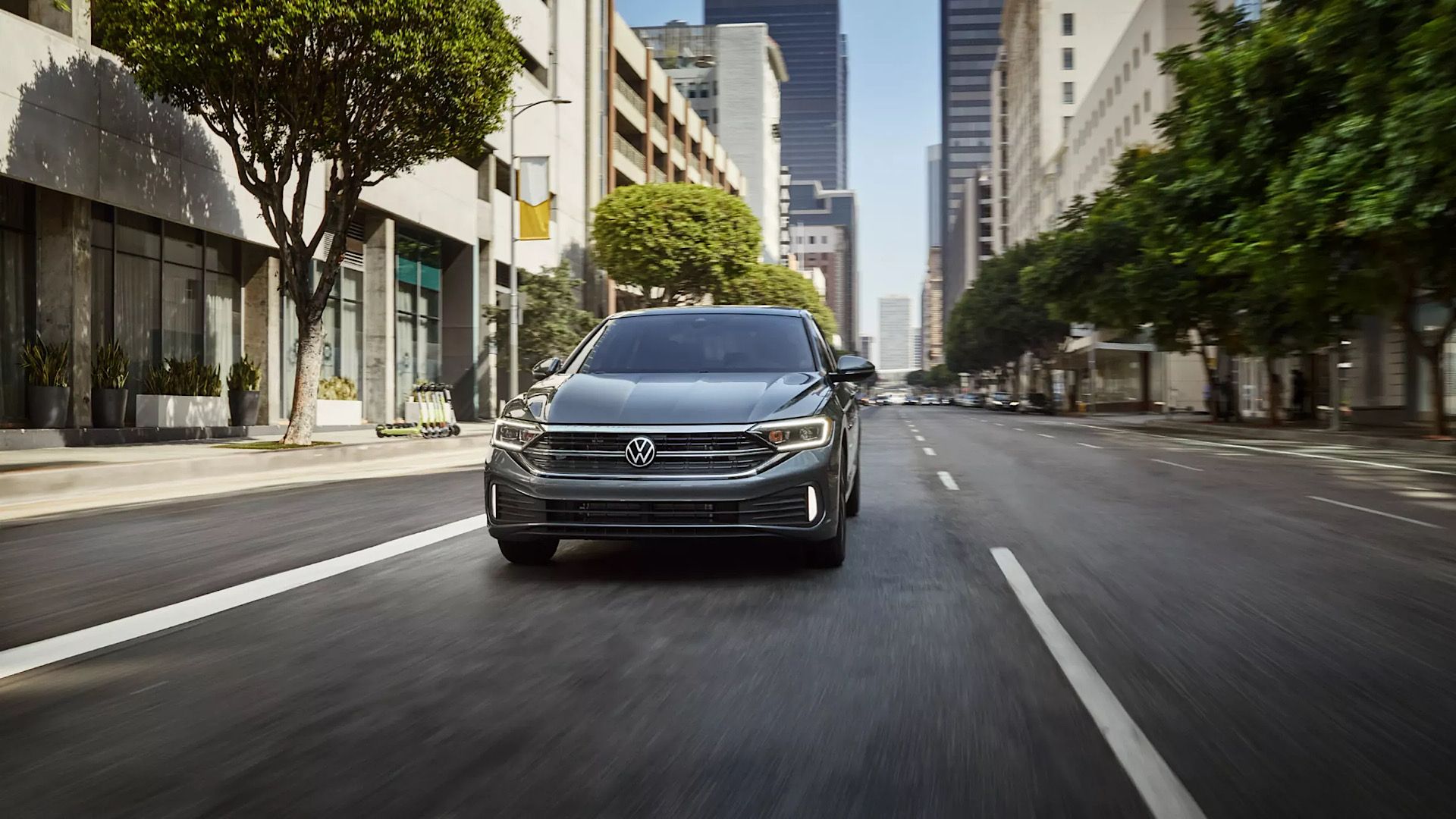 2024 Volkswagen Jetta in silver driving on city street