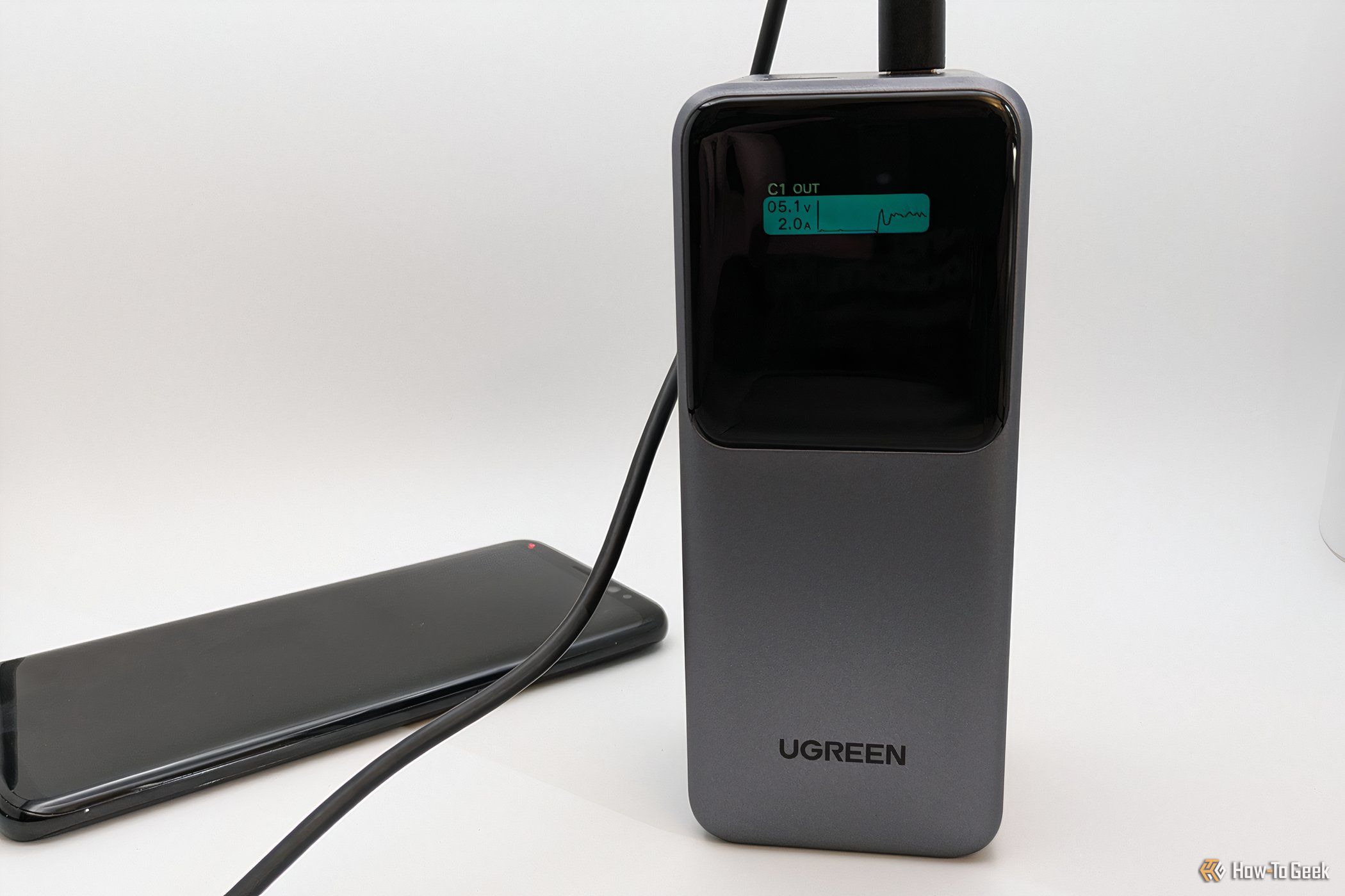 Ugreen Nexode Power Bank 20000mAh digital display showing charging output.