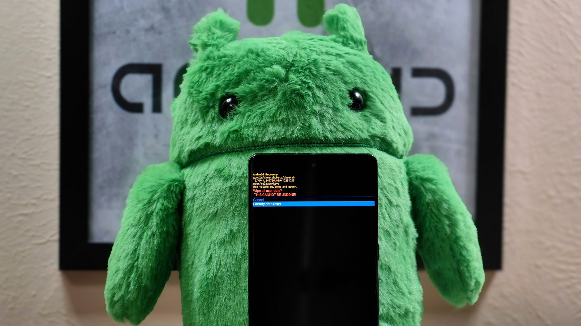 Photo of a Pixel 7 Pro in recovery mode in front of an Android plushie