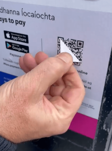 The genuine QR code can be seen underneath the sticker