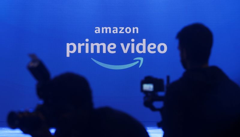 © Reuters. FILE PHOTO: Media are seen in front of an Amazon Prime Video logo during an Amazon Prime Video India launch event in Mumbai, India, April 28, 2022. REUTERS/Francis Mascarenhas/File Photo