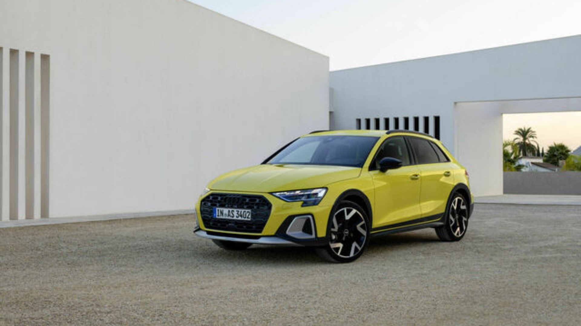 2024 Audi A3 allstreet in yellow posing outside of modern home